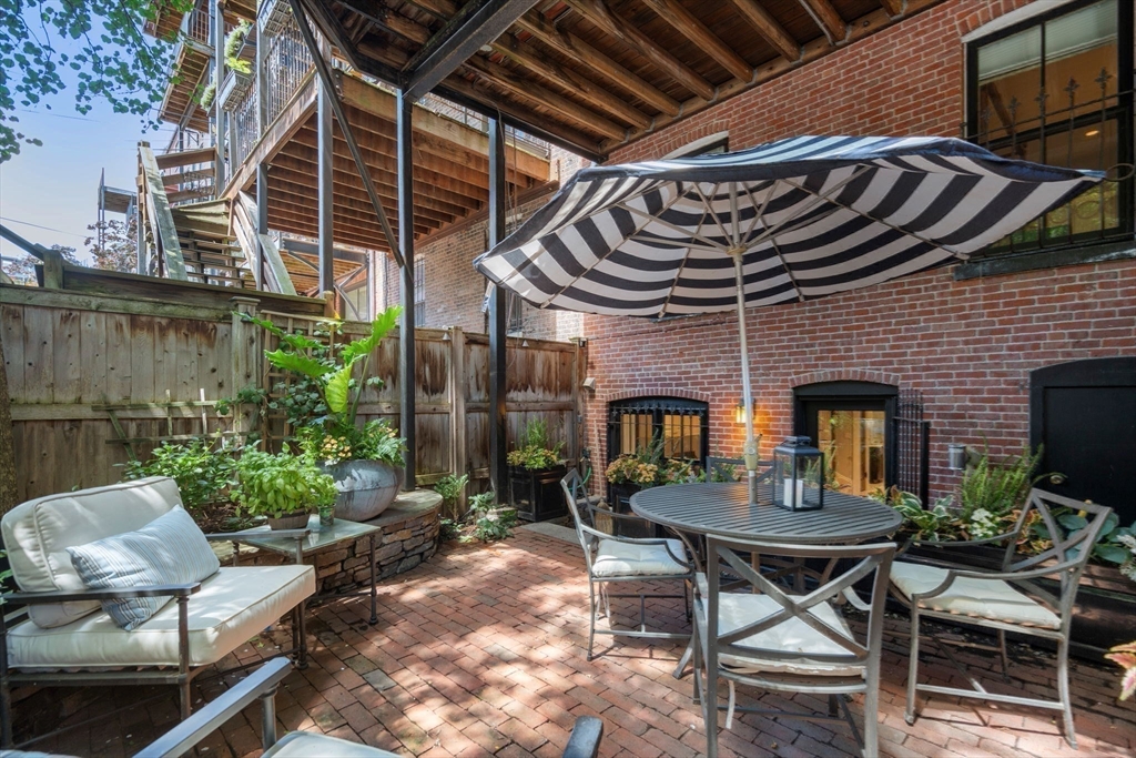 32 Rutland Square, Unit 1 Boston, MA 02118 - Photo 19 of 24 a view of a dinning tables and chairs in backyard of a house