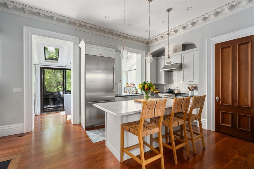 32 Rutland Square, Unit 1 Boston, MA 02118 - Photo 3 of 24 a dining table with chairs and wooden floor