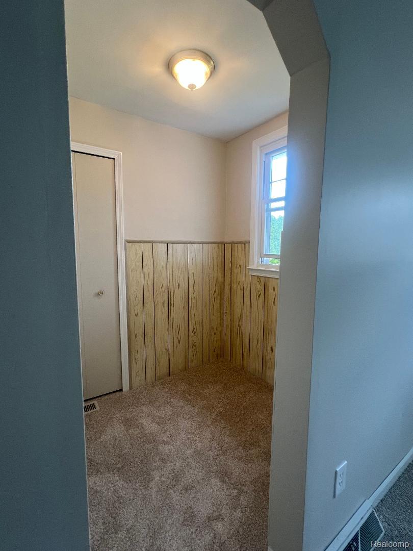 149 Roth Boulevard Clawson, MI 48017 - Photo 10 of 20 Carpeted flooring, wood-panel wainscoting, and a window with natural light