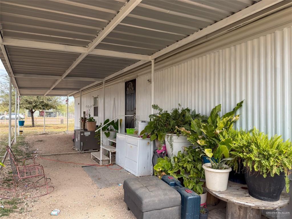 39817 Mile 4 Road Penitas, TX 78576 - Photo 12 of 19 a view of a porch with chairs and potted plants