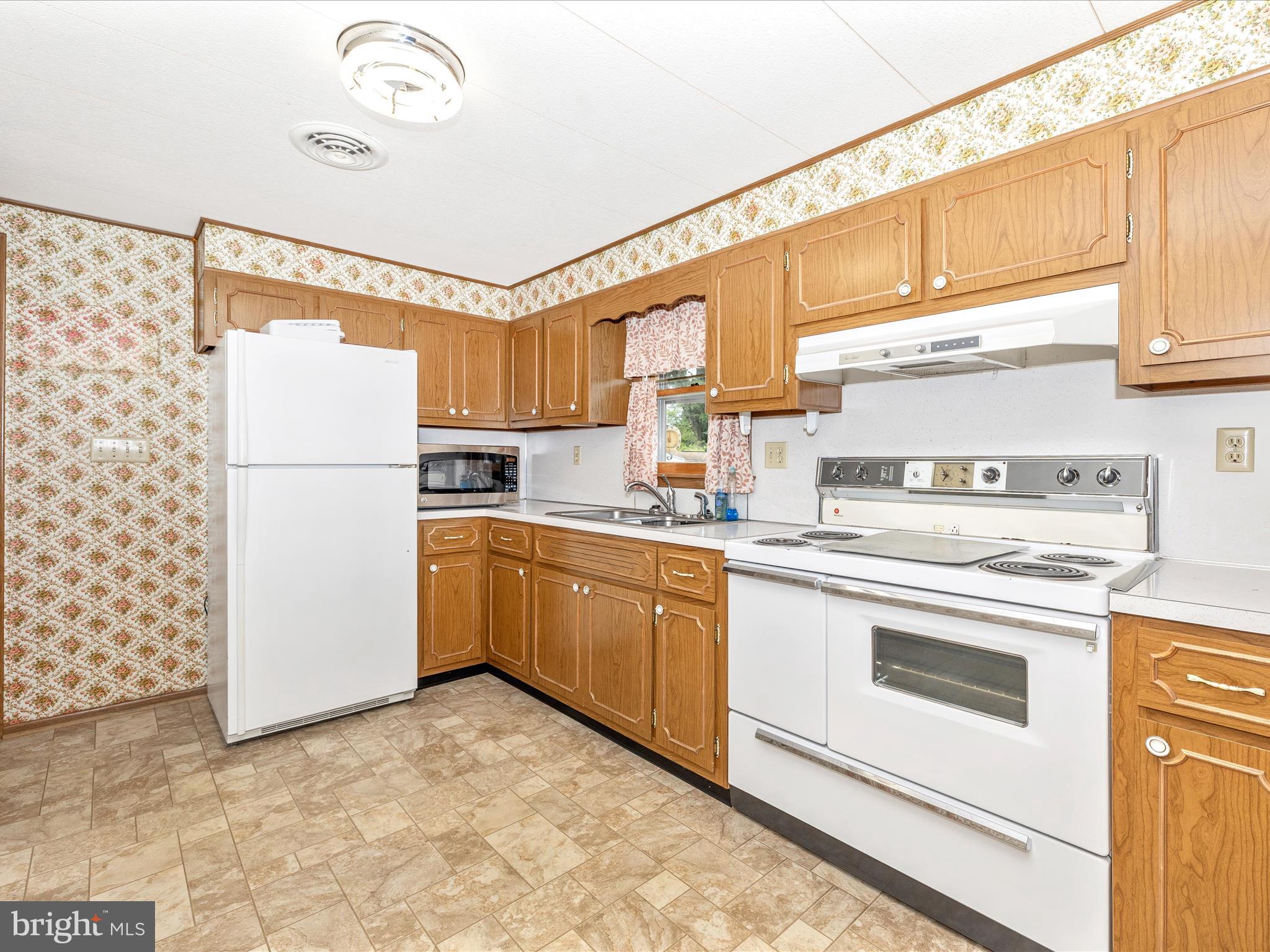 6 Schaller Lane Smithsburg, MD 21783 - Photo 15 of 61 a kitchen with a refrigerator sink and cabinets