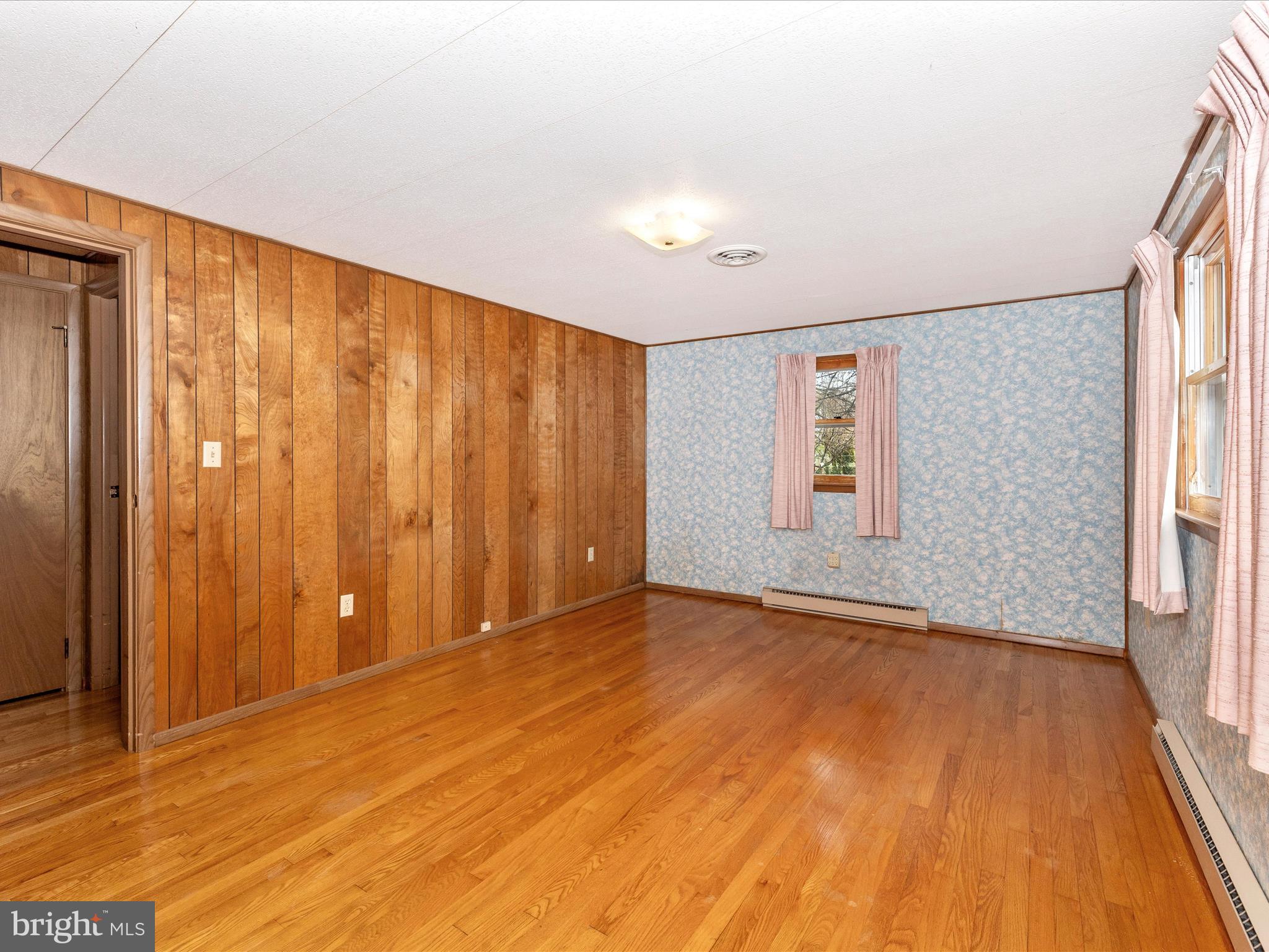 6 Schaller Lane Smithsburg, MD 21783 - Photo 26 of 61 a view of an empty room with wooden floor and a window