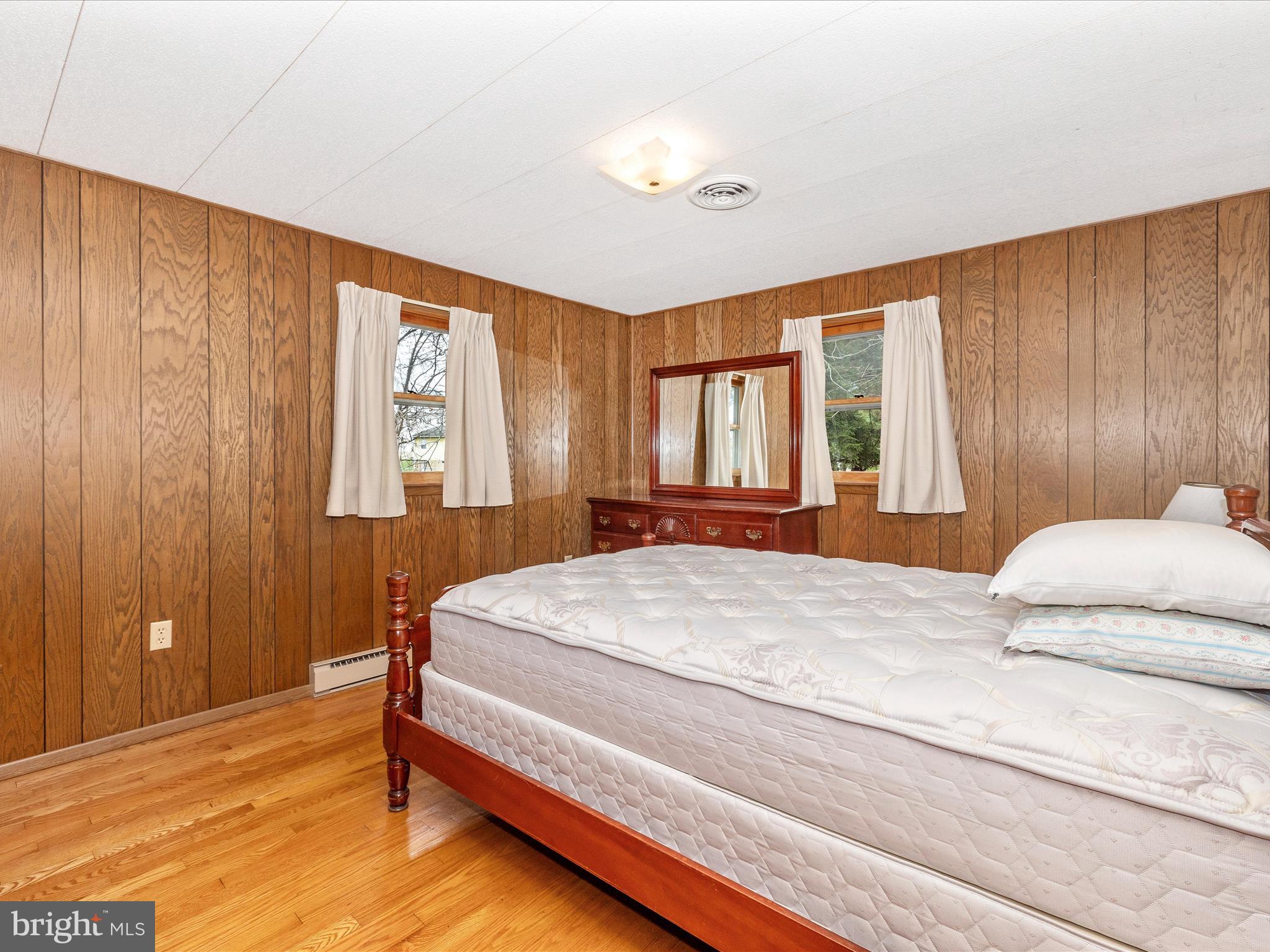 6 Schaller Lane Smithsburg, MD 21783 - Photo 30 of 61 a bedroom with a large bed and wooden floor
