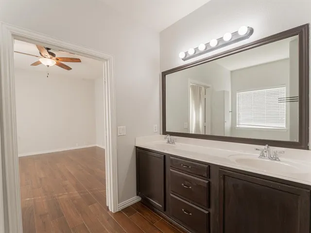 a bathroom with a double vanity sink and a mirror