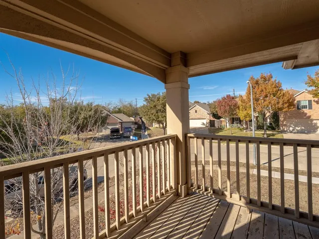 a view of a balcony with wooden floor