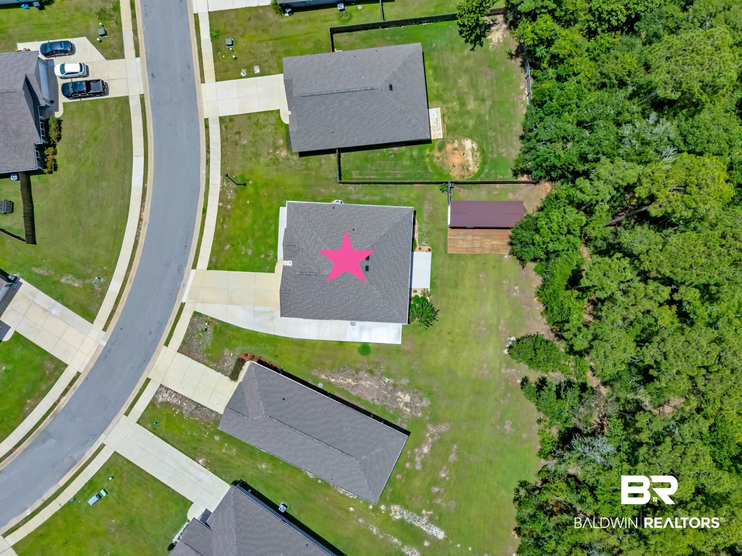 3070 Camino Real Loop Lillian, AL 36549 - Photo 39 of 46 Aerial perspective showcasing a residential property with a shingle roof, concrete driveway, and expansive grassy yard