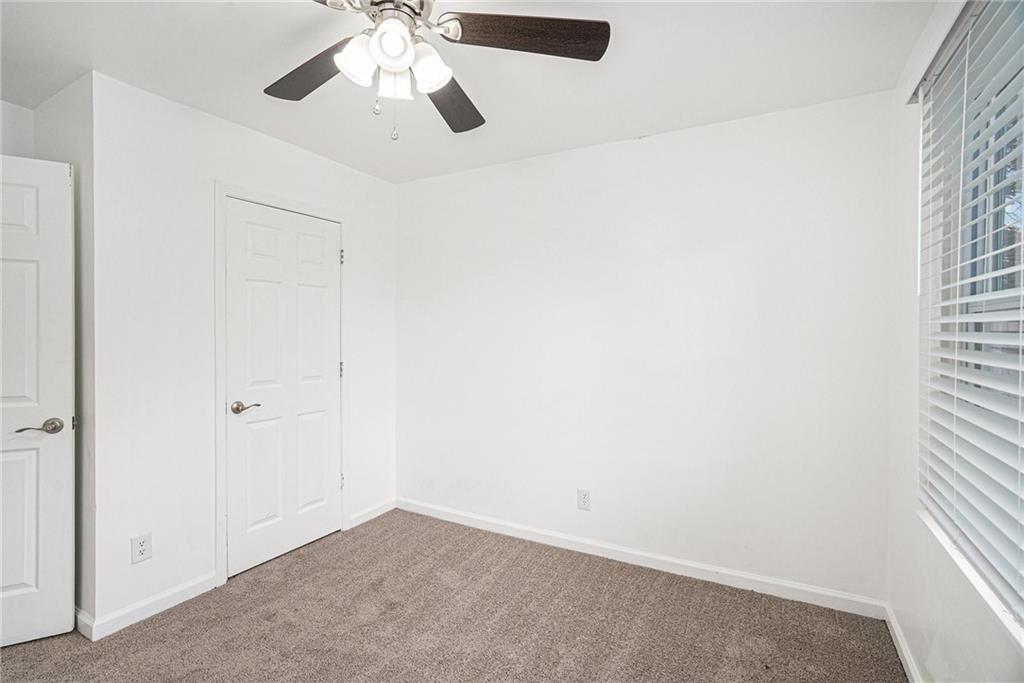 4208 Mistymorn Point Powder Springs, GA 30127 - Photo 16 of 28 an empty room with a window and a fan