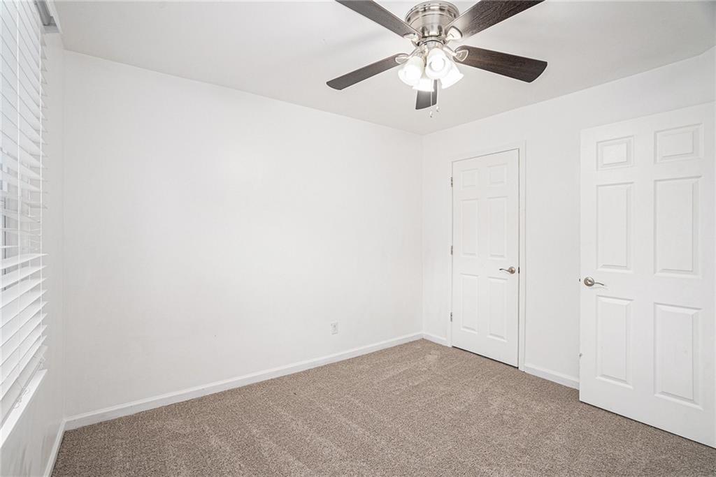 4208 Mistymorn Point Powder Springs, GA 30127 - Photo 18 of 28 an empty room with closet and a chandelier fan