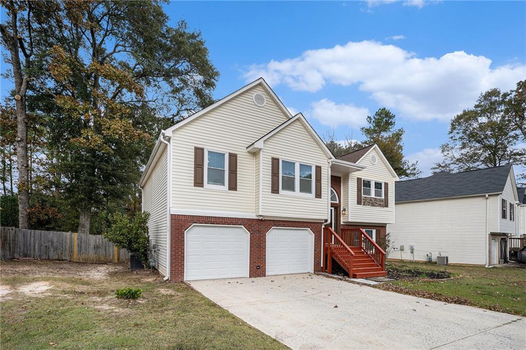 4208 Mistymorn Point Powder Springs, GA 30127 - Photo 2 of 28 a view of a white house with a yard and fence