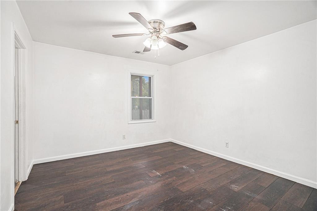 4208 Mistymorn Point Powder Springs, GA 30127 - Photo 21 of 28 an empty room with wooden floor and ceiling fan