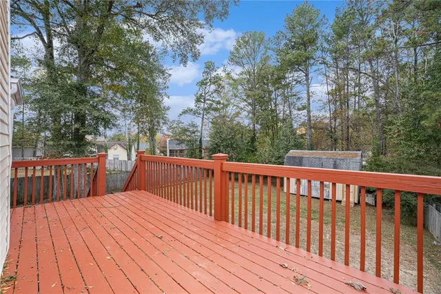 a balcony with wooden floor and fence
