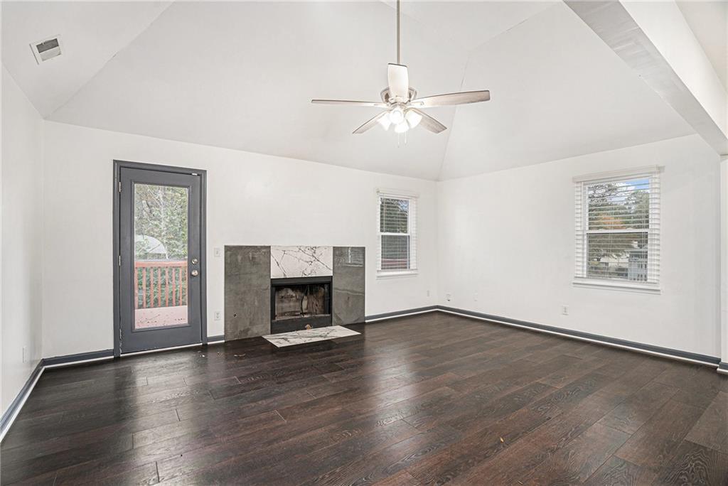 4208 Mistymorn Point Powder Springs, GA 30127 - Photo 5 of 28 an empty room with windows fireplace and wooden floor