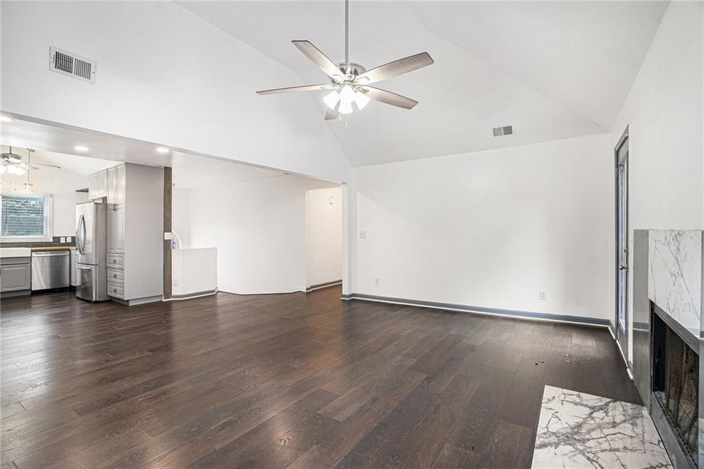 4208 Mistymorn Point Powder Springs, GA 30127 - Photo 7 of 28 a view of an empty room with wooden floor and a ceiling fan
