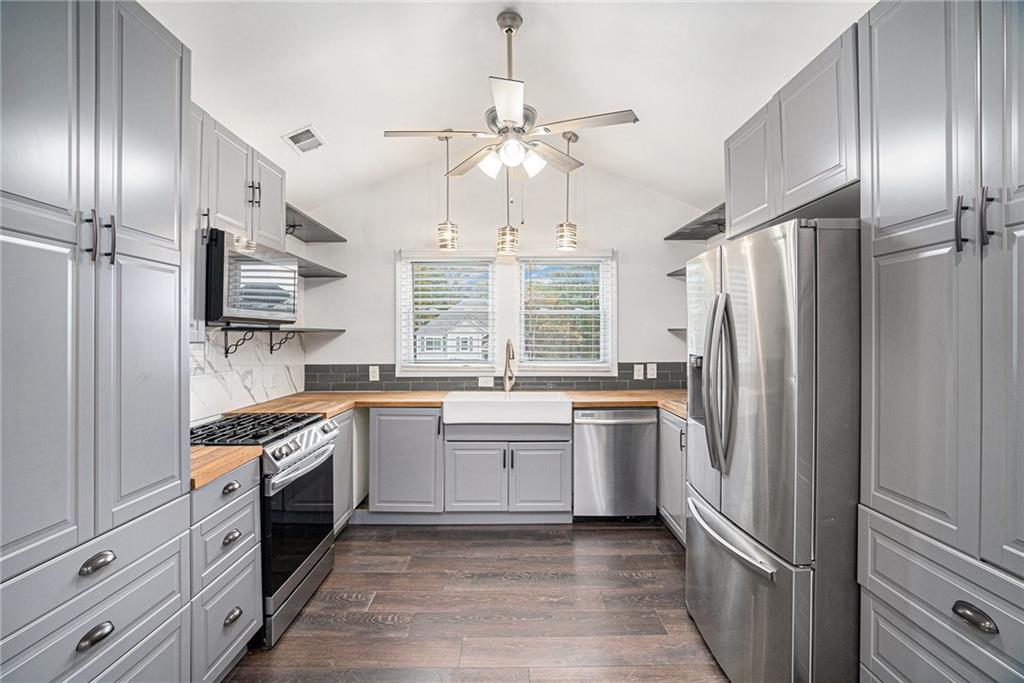 4208 Mistymorn Point Powder Springs, GA 30127 - Photo 8 of 28 a kitchen with stainless steel appliances granite countertop a refrigerator a stove and a sink