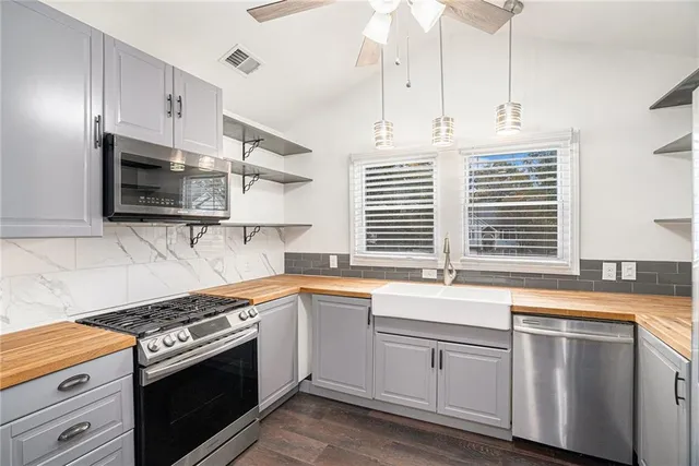 a kitchen with stainless steel appliances white cabinets and a sink