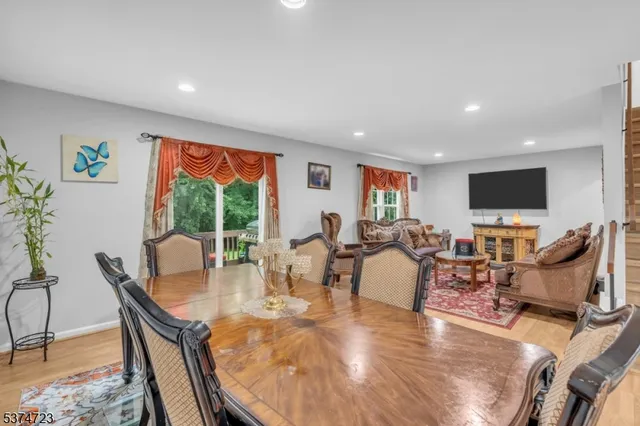 a dining room with furniture a fireplace and a flat screen tv