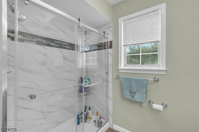 a bathroom with a shower and a window