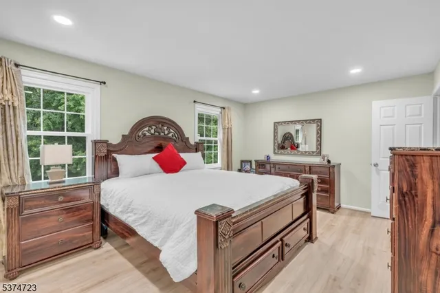 a bedroom with a bed and a large window