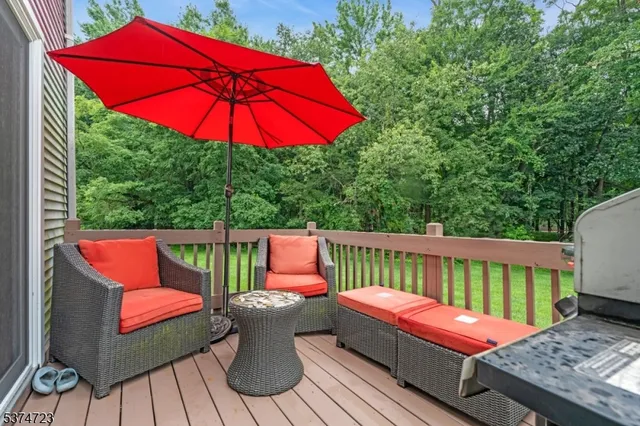 an outdoor sitting area with furniture and wooden deck