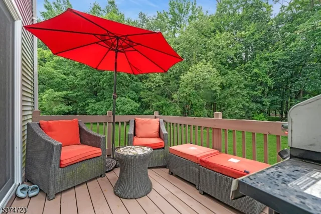 an outdoor sitting area with furniture and wooden deck