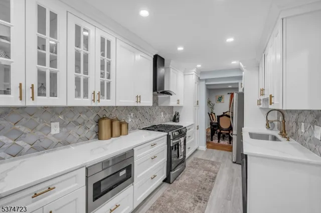 a kitchen with stainless steel appliances granite countertop a sink and cabinets