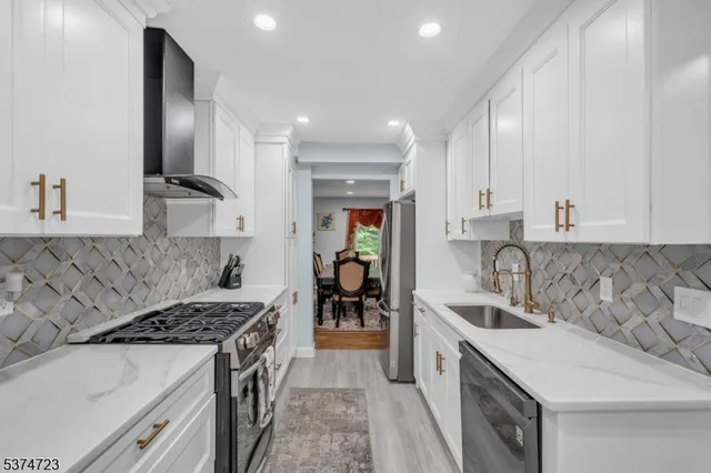 a kitchen with a sink stove top oven and cabinets