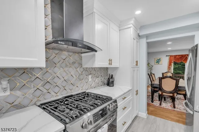 a kitchen with a stove and a white cabinets