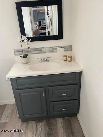 a bathroom with a sink vanity and mirror