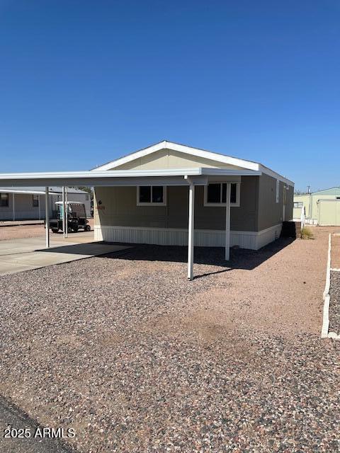 2481 West Broadway Avenue, Unit 71 Apache Junction, AZ 85120 - Photo 2 of 18 a front view of a house with a yard