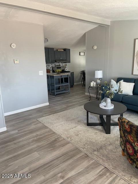 2481 West Broadway Avenue, Unit 71 Apache Junction, AZ 85120 - Photo 7 of 18 a living room with furniture and a dining table with kitchen view