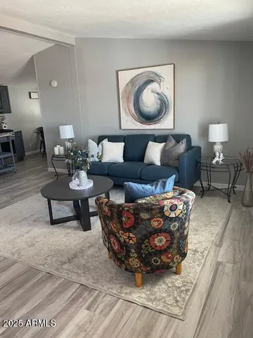 a living room with furniture and a painting on the wall