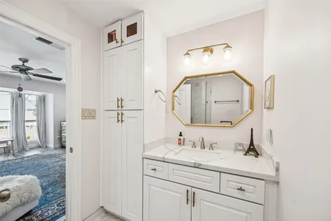 a bathroom with a sink vanity and a mirror