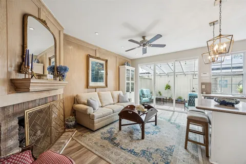 a living room with furniture a chandelier and a fireplace