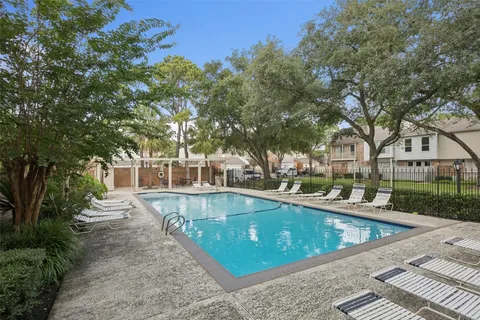 a view of a house with pool and sitting area