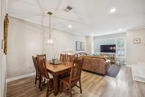 a view of a dining room with furniture wooden floor and chandelier