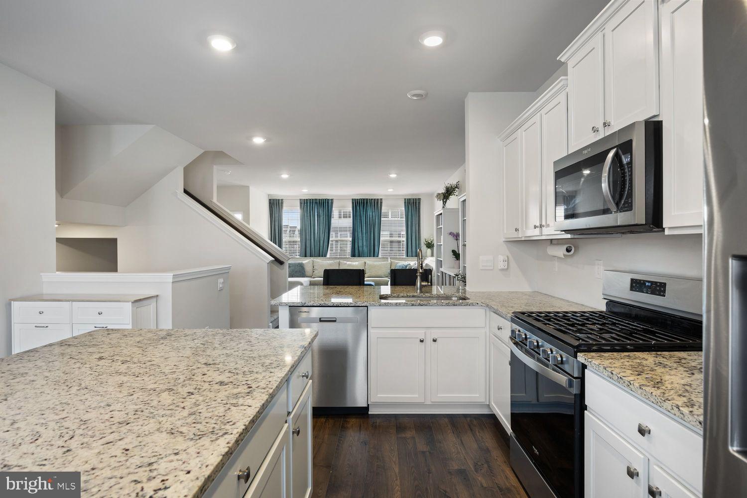 69 Sister's Farmstead Rd Mount Mount Laurel, NJ 08054 - Photo 12 of 44 a kitchen with stainless steel appliances granite countertop a sink stove microwave and cabinets