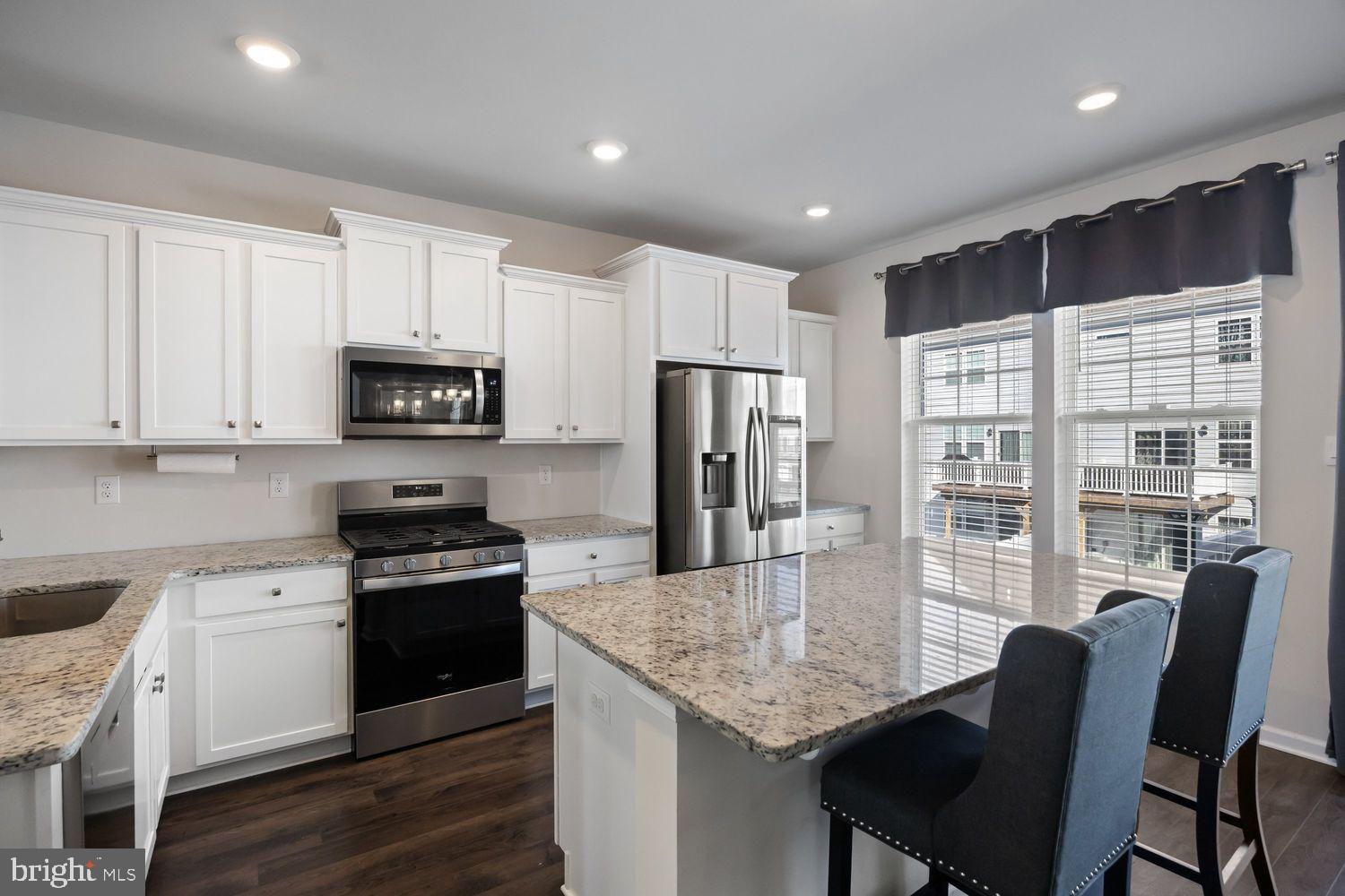 69 Sister's Farmstead Rd Mount Mount Laurel, NJ 08054 - Photo 13 of 44 a kitchen with stainless steel appliances granite countertop a stove a refrigerator a sink a stove with white cabinets and wooden floor