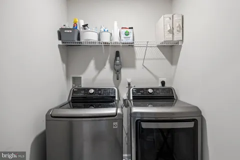 a bedroom with a large bed and a flat tv screen on dresser
