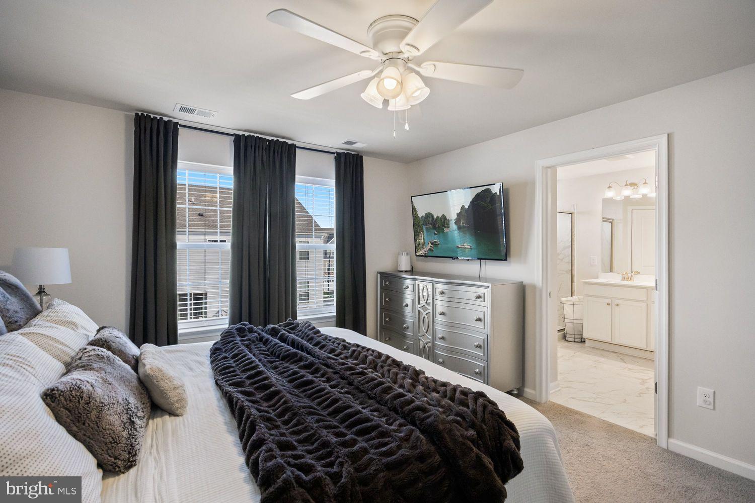 69 Sister's Farmstead Rd Mount Mount Laurel, NJ 08054 - Photo 24 of 44 a bedroom with a large bed and a flat tv screen on dresser