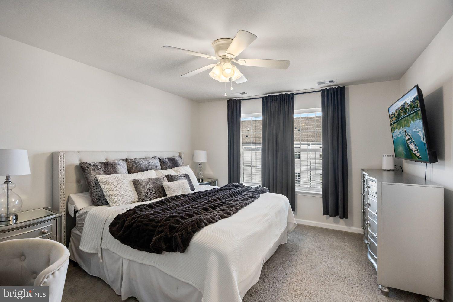 69 Sister's Farmstead Rd Mount Mount Laurel, NJ 08054 - Photo 25 of 44 a bedroom with a large bed and a chandelier