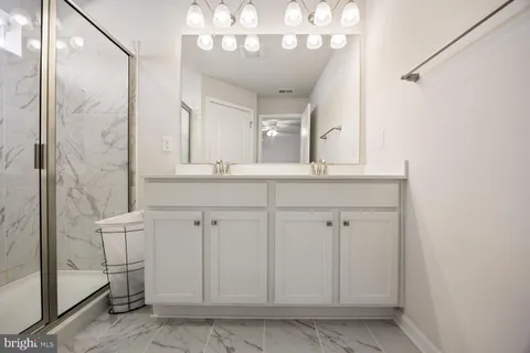 a bathroom with a shower and a sink a mirror