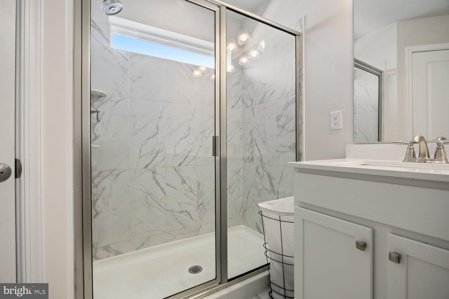 69 Sister's Farmstead Rd Mount Mount Laurel, NJ 08054 - Photo 28 of 44 a bathroom with a shower and a sink a mirror