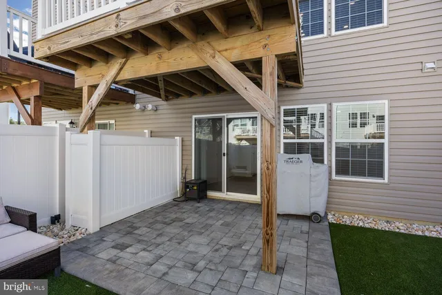 a view of backyard with barbeque grill and outdoor seating