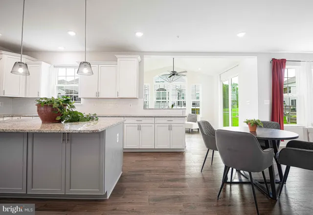 a kitchen with a table chairs sink and cabinets