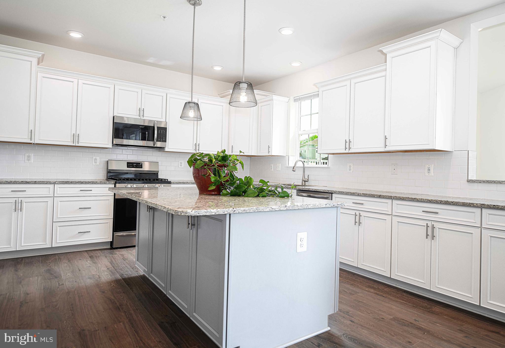 1218 Up And Over Lane Aberdeen, MD 21001 - Photo 20 of 40 a kitchen with kitchen island white cabinets and white appliances