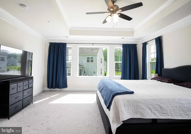 a bedroom with a large bed and a chandelier