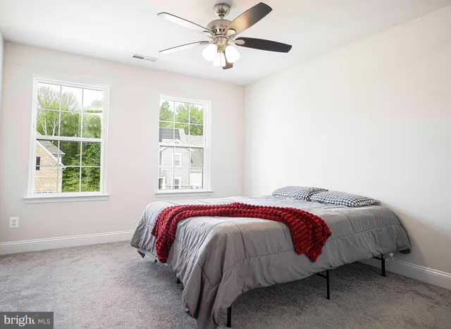 a bed sitting in a bedroom next to a window