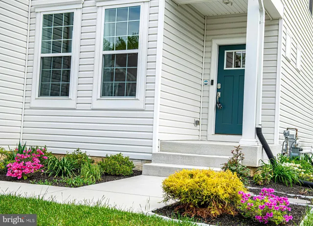a front view of a house with a yard and fountain