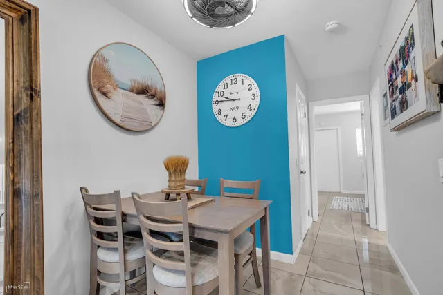 a view of a dining area with furniture and a mirror