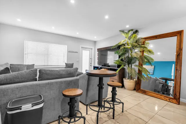 a living room with furniture and a potted plant